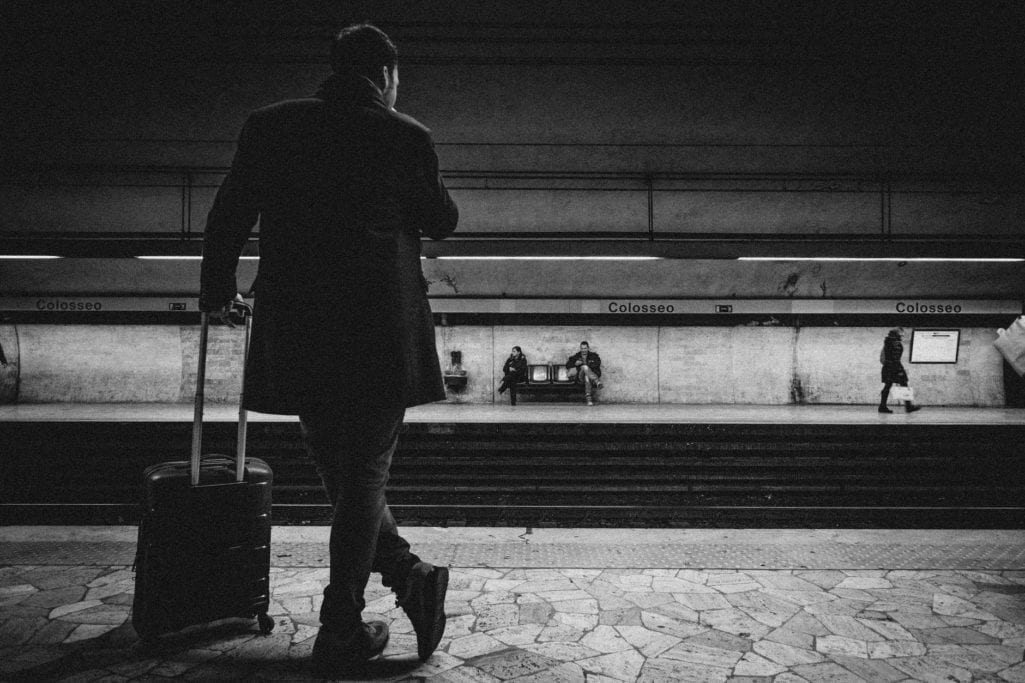 man with luggage bag on train station