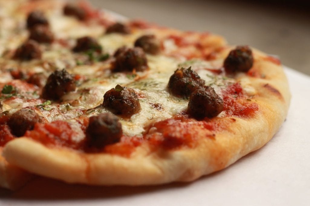 pizza with raisins on top