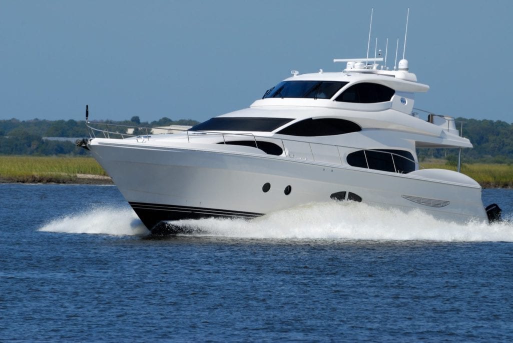 white yacht on running on blue body of water during daytime