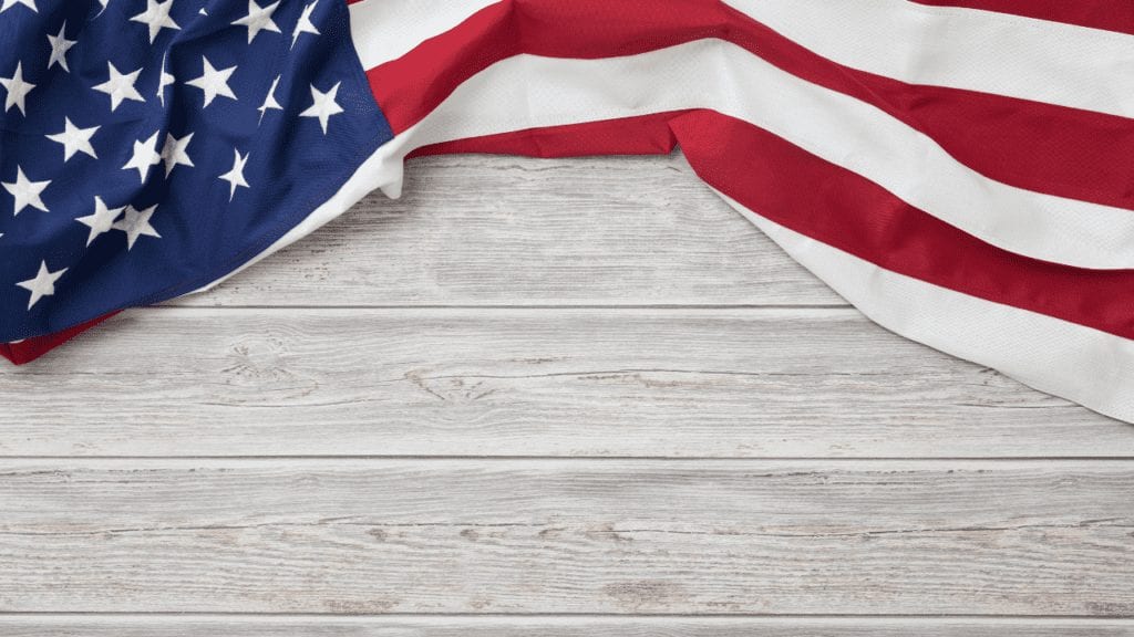 Image of Flag draped over white wood planking