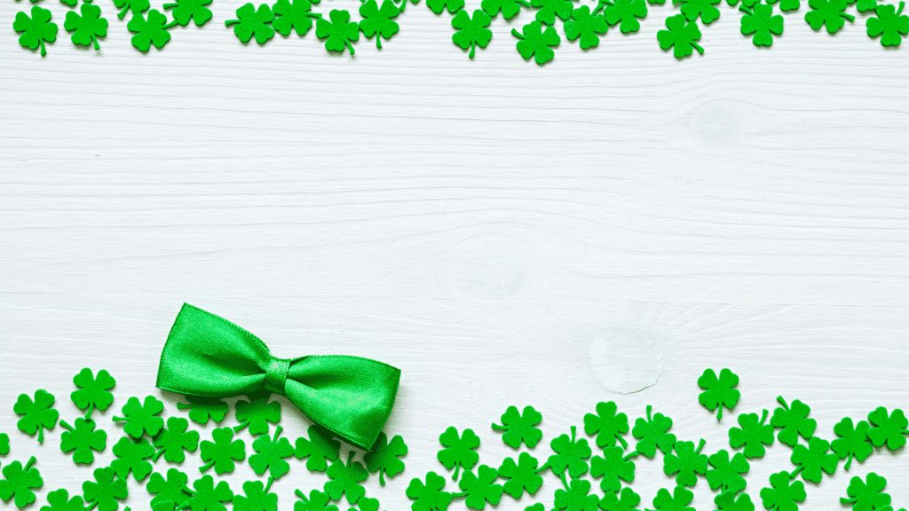 Four leaf clovers on white background with bowtie