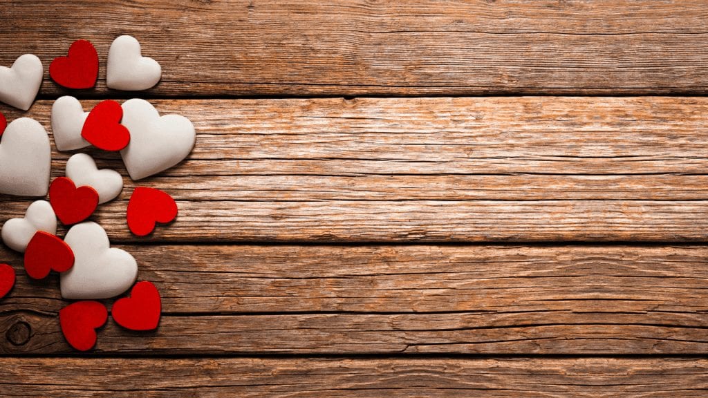 Image of red and white hearts on horizontal wood siding