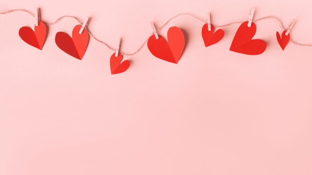 Image of red paper hearts clothpinned onto a string