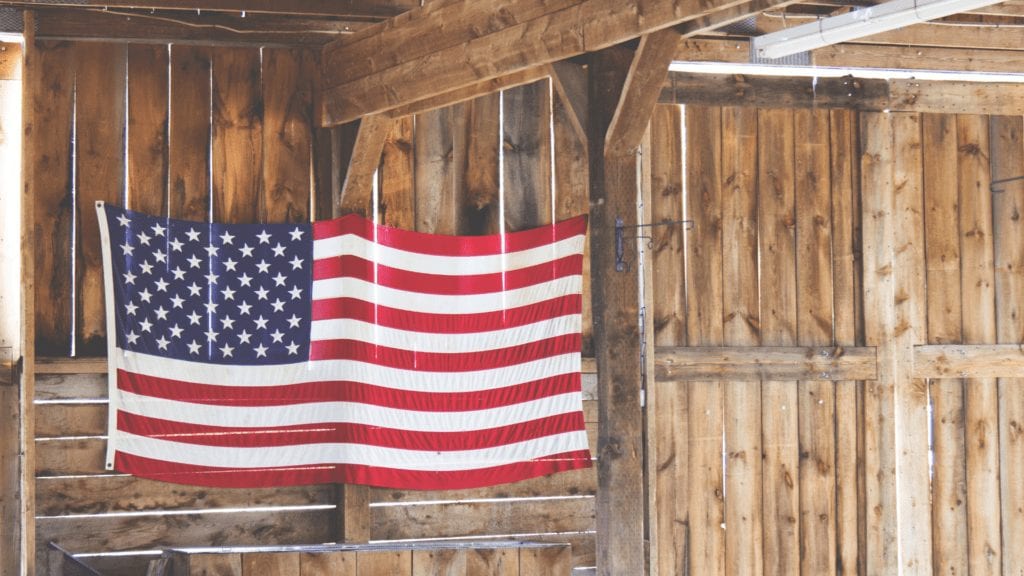 Image of flag draped on barn wall