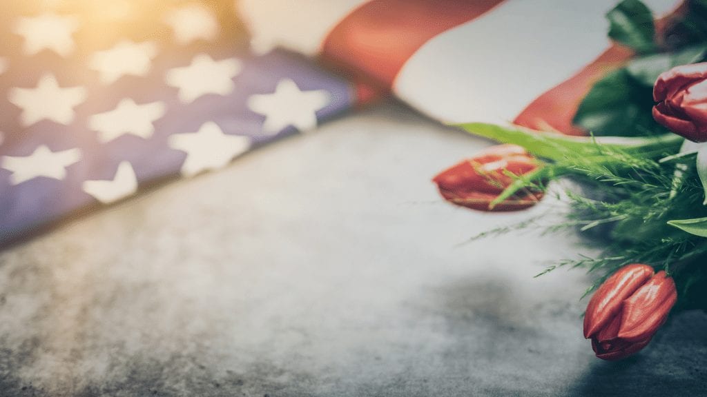 image of flag over cement floor with lilly flowers