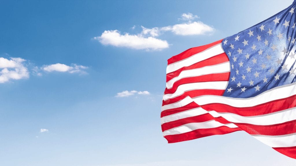 Image of flag waving in blue sky