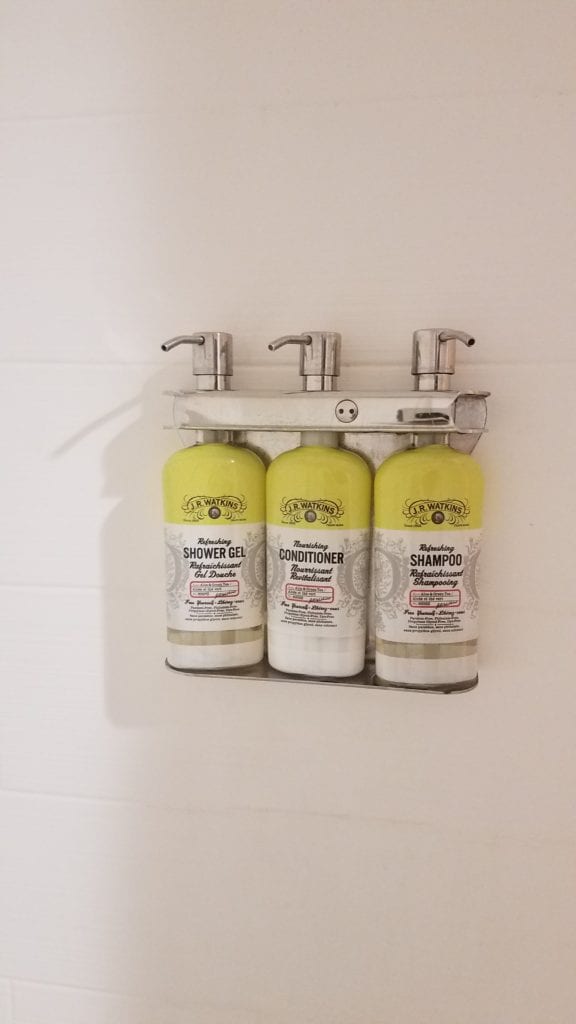 a group of shampoo bottles on a wall
