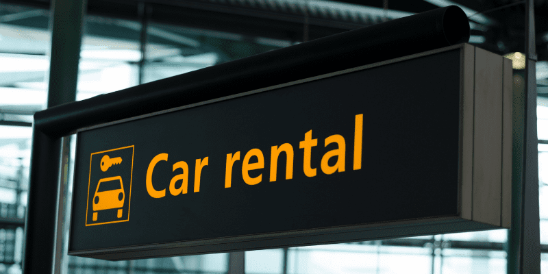Image of a car rental sign at an airport
