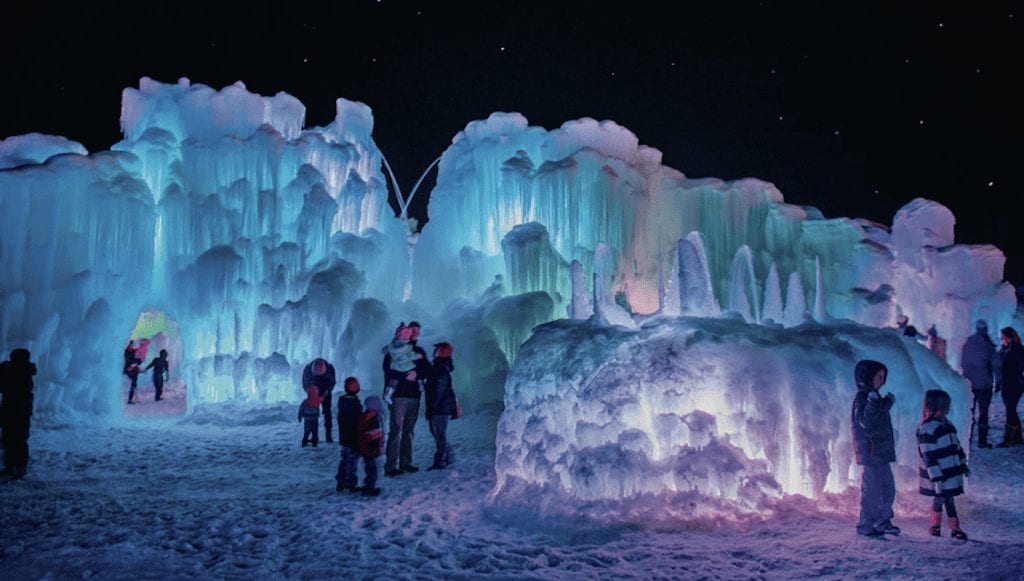 a group of people standing in front of ice sculptures
