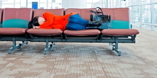 Image of woman sleeping in an airport