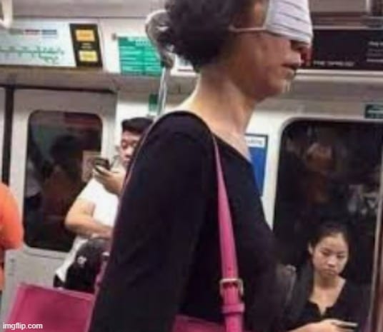 a woman with blindfold on her face