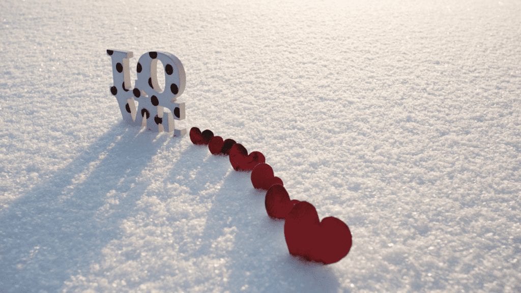 a white and red hearts in the snow