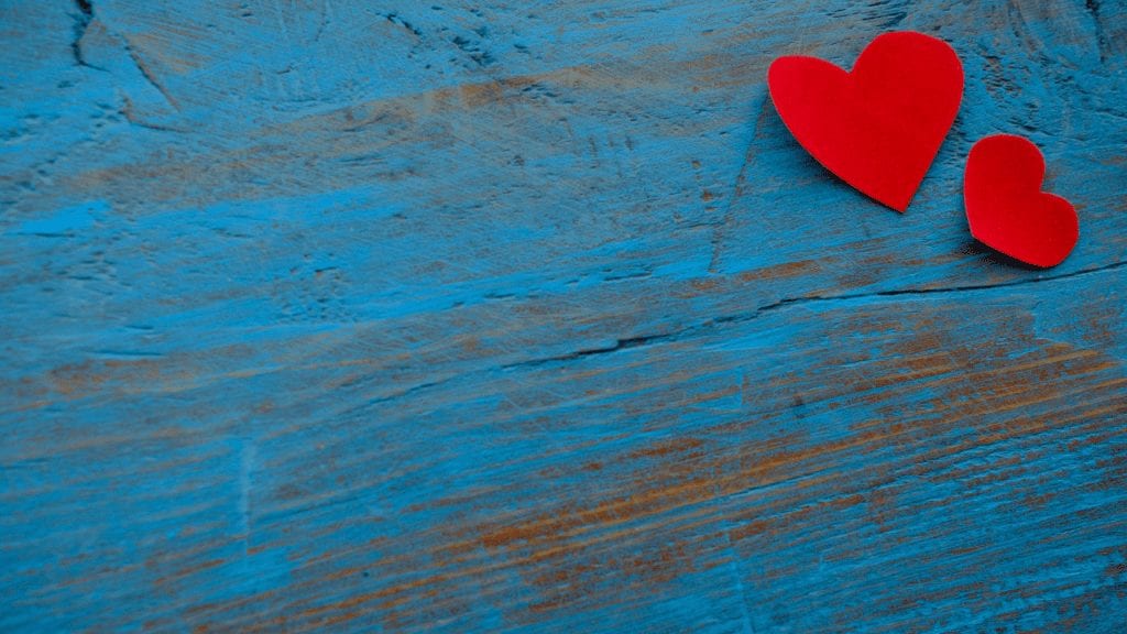 a red heart on a blue surface