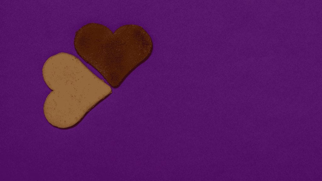 a heart shaped cookies on a purple surface