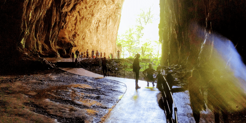 people walking in a cave